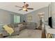 Cozy living room with a large sectional sofa, and ceiling fan at 23516 Peachland Blvd, Port Charlotte, FL 33954
