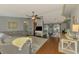 Open-concept living area with ceiling fan, hardwood floors, and a neutral color palette with a peek into the dining area at 23516 Peachland Blvd, Port Charlotte, FL 33954