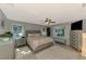 Light-filled main bedroom with neutral walls, tile floor, ceiling fan, and plenty of natural light at 23516 Peachland Blvd, Port Charlotte, FL 33954