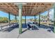 Picnic Pavilion #2, a wooden structure with picnic tables and view of community buildings at 23516 Peachland Blvd, Port Charlotte, FL 33954