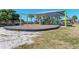 Community playground under a sunshade with swings and slides on a sunny day at 23516 Peachland Blvd, Port Charlotte, FL 33954