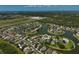 Panoramic aerial showcasing this beautiful home and lake with lush landscaping, with tranquil views within a desirable community at 24477 Lakeside Mnr, Punta Gorda, FL 33980