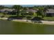 Backyard of the property featuring a scenic lake view and lush landscaping at 24477 Lakeside Mnr, Punta Gorda, FL 33980