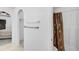 Bright bathroom features a shower with a decorative curtain, and arched doorway to an adjacent bedroom at 24477 Lakeside Mnr, Punta Gorda, FL 33980