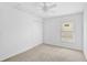 A bright bedroom featuring carpeted floors, a ceiling fan, a closet, and a light at 24477 Lakeside Mnr, Punta Gorda, FL 33980