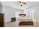Bedroom features neutral carpet, fan and ensuite bath at 24477 Lakeside Mnr, Punta Gorda, FL 33980