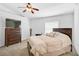 Bedroom features neutral carpet, fan and large dresser at 24477 Lakeside Mnr, Punta Gorda, FL 33980