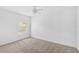 A bright bedroom featuring carpeted floors, a ceiling fan, and a window at 24477 Lakeside Mnr, Punta Gorda, FL 33980
