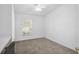 Bright bedroom features carpeted floors, a ceiling fan and light, and a built-in desk with a chair at 24477 Lakeside Mnr, Punta Gorda, FL 33980