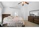 Bedroom features neutral carpet, fan and large dresser at 24477 Lakeside Mnr, Punta Gorda, FL 33980