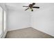 A bright bedroom featuring carpeted floors, a ceiling fan, a closet, and a light at 24477 Lakeside Mnr, Punta Gorda, FL 33980
