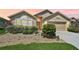 Charming single-story home with landscaped front yard, a well-manicured lawn, and an attached garage at 24477 Lakeside Mnr, Punta Gorda, FL 33980