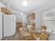 Bright kitchen with wood cabinets, updated appliances, and a breakfast nook with plenty of natural light at 24477 Lakeside Mnr, Punta Gorda, FL 33980