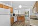Well-lit kitchen with warm wood cabinets, modern appliances, and an open view to the living space at 24477 Lakeside Mnr, Punta Gorda, FL 33980