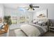 A bright main bedroom featuring large windows, modern decor and a comfortable well-lit space at 24477 Lakeside Mnr, Punta Gorda, FL 33980