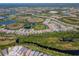 An aerial view of a residential neighborhood with lakes and natural landscape in the community at 264 Caserta Ct, Nokomis, FL 34275