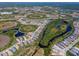 Expansive aerial view showcasing the community, lakes, and lush green surroundings at 264 Caserta Ct, Nokomis, FL 34275