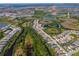 An aerial view of a residential neighborhood with lakes and natural landscape in the community at 264 Caserta Ct, Nokomis, FL 34275