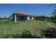 Expansive backyard featuring a well-manicured lawn and a charming screened-in patio at 264 Caserta Ct, Nokomis, FL 34275