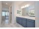 Bathroom featuring double sinks with granite counters and view of a luxurious Primary bedroom at 264 Caserta Ct, Nokomis, FL 34275