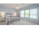 Serene bedroom with soft blue walls, a decorative chandelier, and large window with sheer curtains at 264 Caserta Ct, Nokomis, FL 34275