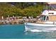 Classic boat sailing by a rocky shoreline, with people enjoying the scenery in the background at 264 Caserta Ct, Nokomis, FL 34275