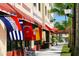 Storefronts with awnings and international flags on a vibrant commercial street at 264 Caserta Ct, Nokomis, FL 34275