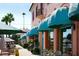 Charming street view with awnings over storefronts, with outdoor tables and chairs visible at 264 Caserta Ct, Nokomis, FL 34275