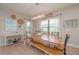 Bright dining room with large wooden table, decorative chandelier, and natural light from large windows at 264 Caserta Ct, Nokomis, FL 34275