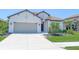 Charming single-story home with a well-manicured lawn, two-car garage, and tile roof, perfect for curb appeal at 264 Caserta Ct, Nokomis, FL 34275