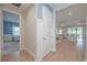 Bright hallway featuring wood floors and doorways leading to the bedroom and living room at 264 Caserta Ct, Nokomis, FL 34275