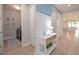 Hallway with a console table, laundry room access, and views of a bright living area at 264 Caserta Ct, Nokomis, FL 34275