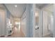 Bright hallway with light wood floors, decorative wainscoting and views into the living space and a bedroom at 264 Caserta Ct, Nokomis, FL 34275