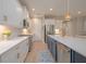 Bright modern kitchen with stainless steel appliances, white cabinets, and island with quartz countertop at 264 Caserta Ct, Nokomis, FL 34275