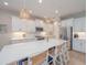 Bright, open kitchen featuring a large island, stainless steel appliances, and pendant lighting at 264 Caserta Ct, Nokomis, FL 34275
