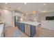Modern kitchen with a large island, stainless steel appliances, and open layout, ideal for Gathering gatherings at 264 Caserta Ct, Nokomis, FL 34275