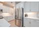 Modern kitchen boasts white cabinets, quartz countertops and stainless steel appliances at 264 Caserta Ct, Nokomis, FL 34275
