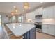 Spacious kitchen featuring a large island, pendant lighting, stainless steel appliances, and open layout at 264 Caserta Ct, Nokomis, FL 34275