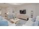 Stylish living room with comfortable seating, artistic decor and a large TV at 264 Caserta Ct, Nokomis, FL 34275