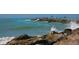 Rock breakwater with people fishing in the sea with the waves crashing against rocks at 264 Caserta Ct, Nokomis, FL 34275