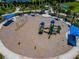 Aerial view of the community playground with swings, slides, and covered seating areas for residents to enjoy at 264 Caserta Ct, Nokomis, FL 34275