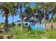 Welcome to Venice Beach sign surrounded by lush greenery and palm trees, creating a tropical entrance at 264 Caserta Ct, Nokomis, FL 34275