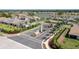 Aerial view of community entrance, showcasing lush landscaping, community lake, and various housing options at 268 Ibiza Loop, Venice, FL 34292