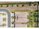 A bird's-eye view of a home highlighting the backyard with a patio area, greenery, and privacy fencing at 268 Ibiza Loop, Venice, FL 34292