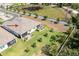 Aerial of home featuring a spacious backyard with young palm trees, patio area, and lush green grass at 268 Ibiza Loop, Venice, FL 34292
