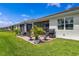 Brick patio features comfortable seating and grill, screened in for outdoor enjoyment at 268 Ibiza Loop, Venice, FL 34292
