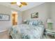 Cozy bedroom featuring leaf-themed decor and a glimpse into the ensuite bathroom at 268 Ibiza Loop, Venice, FL 34292