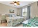 Bright bedroom featuring a ceiling fan, coordinated decor, and a window letting in natural light at 268 Ibiza Loop, Venice, FL 34292