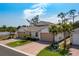 Inviting single-story home with a brick driveway and lush landscaping at 268 Ibiza Loop, Venice, FL 34292