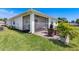 Exterior view of a home showcasing a screened-in patio and well-maintained lawn at 268 Ibiza Loop, Venice, FL 34292